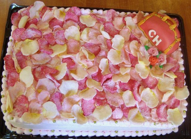 Pastel de fresas con crema y pétalos de rosa con aplicación de figura de fondant suizo